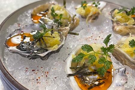 BC Kusshi oysters with fermented cabbage and spices at farm to table restaurant Flea Street in Menlo Park, CA